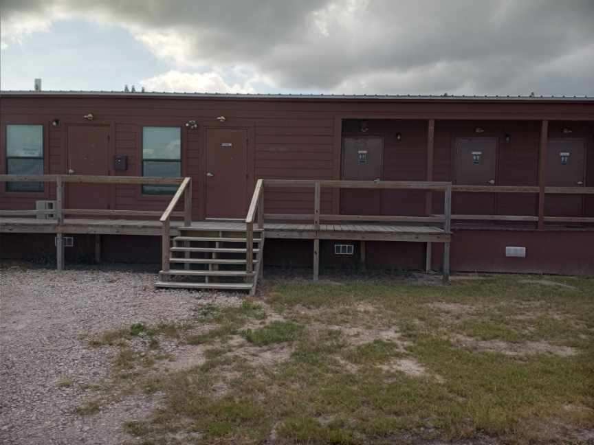 Double Time RV Park office and private shower and restroom building with covered wooden deck in Alvin, Texas